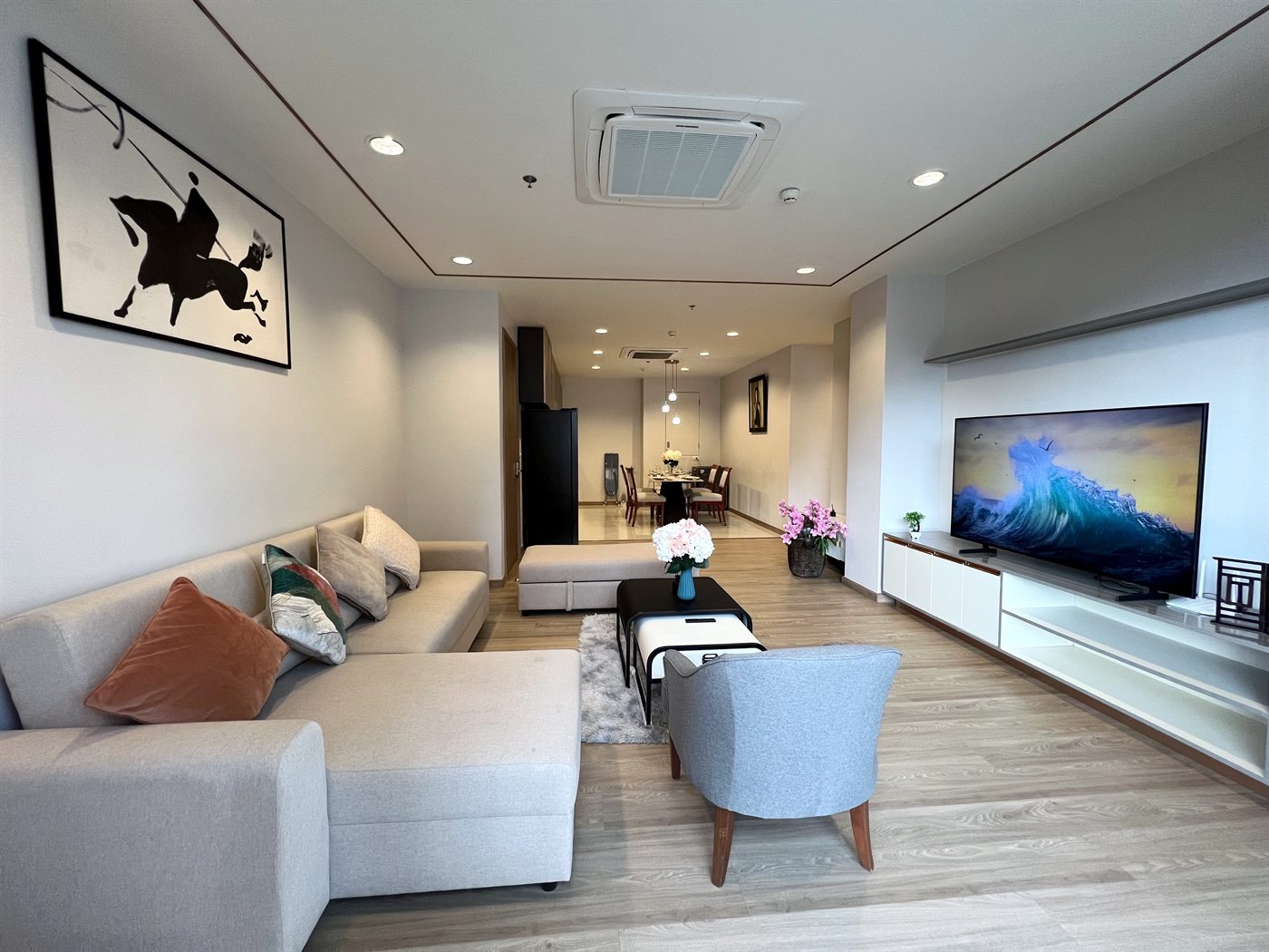 Residence 403 two-bedroom living room with sofa and large smart TV